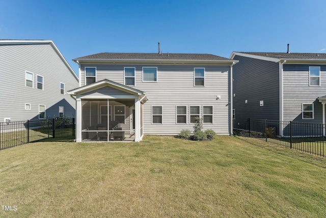 back of house with a yard and a sunroom