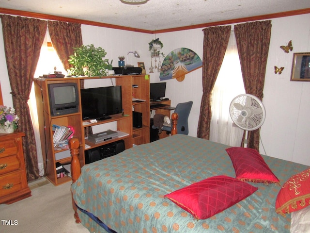 carpeted bedroom featuring ornamental molding and a textured ceiling