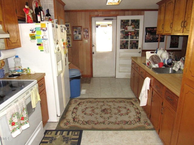 kitchen with white range with electric stovetop, ornamental molding, wooden walls, and light tile patterned floors