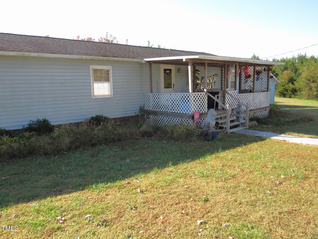 ranch-style home with covered porch and a front lawn