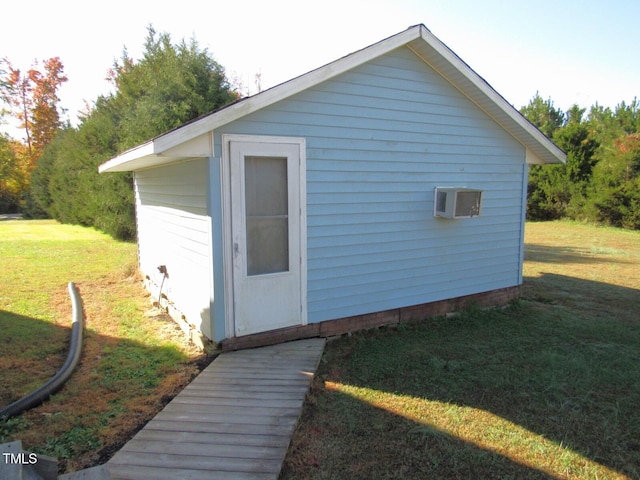 view of outbuilding with a yard