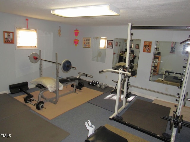 exercise room featuring a textured ceiling