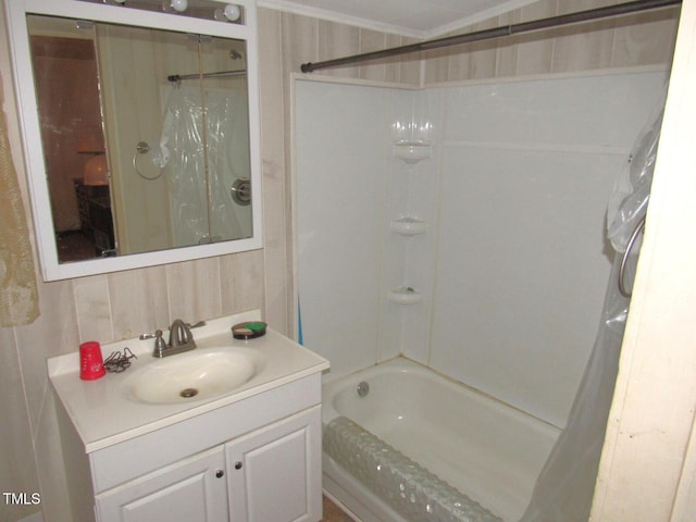 bathroom with vanity, crown molding, and  shower combination