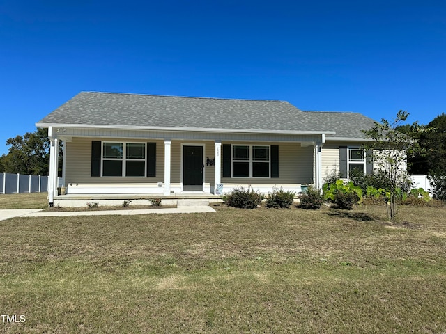 view of front of property with covered porch and a front yard