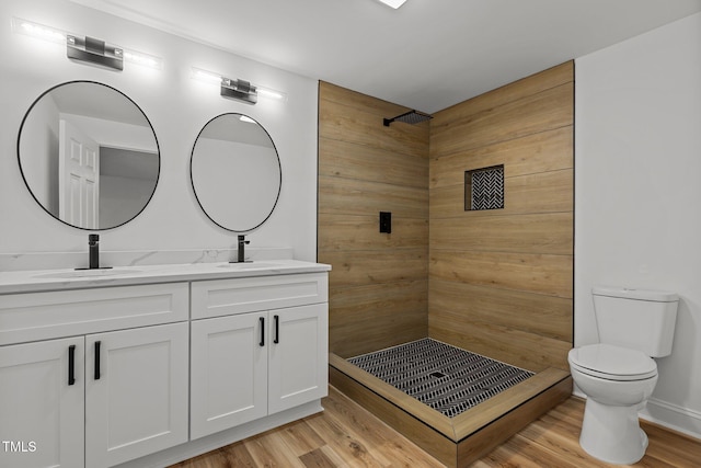 bathroom featuring vanity, wood-type flooring, toilet, and walk in shower