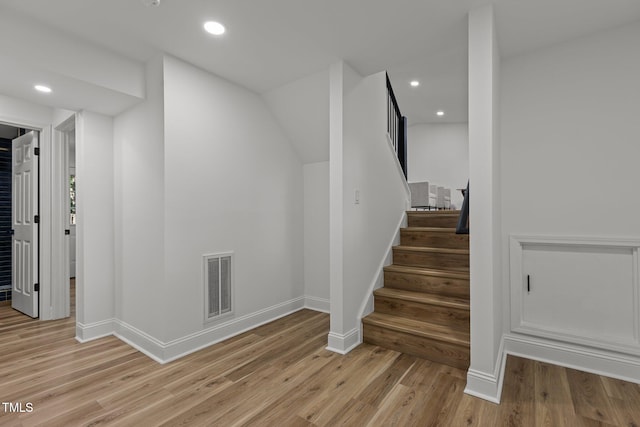 staircase featuring hardwood / wood-style floors