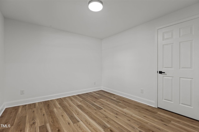 unfurnished room with light wood-type flooring