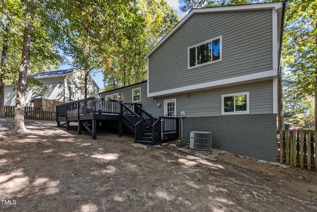 rear view of property featuring cooling unit and a wooden deck