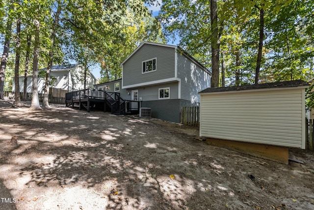 rear view of house featuring cooling unit and a deck