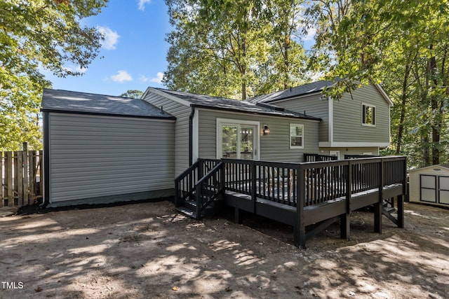 rear view of property with a storage shed and a deck