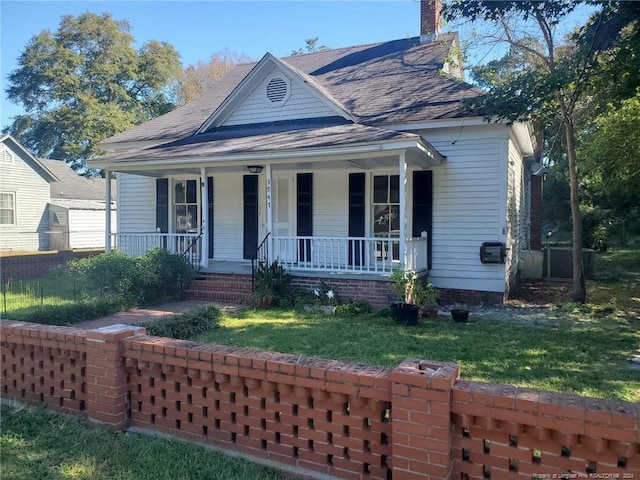 bungalow-style home with covered porch and a front lawn