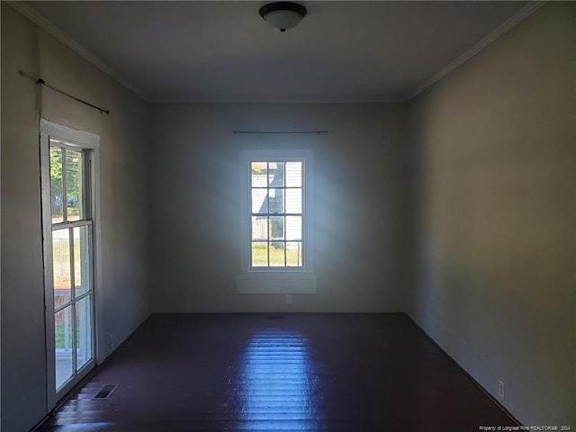 empty room with ornamental molding and dark wood-type flooring