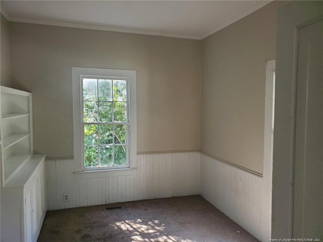 carpeted spare room with crown molding