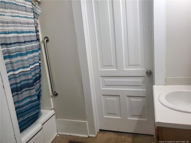 bathroom with vanity, shower / bath combination with curtain, and tile patterned flooring