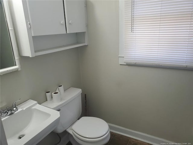 bathroom featuring sink, toilet, and tile patterned flooring