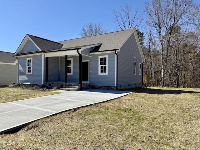 ranch-style house featuring a porch, a front yard, and a shingled roof