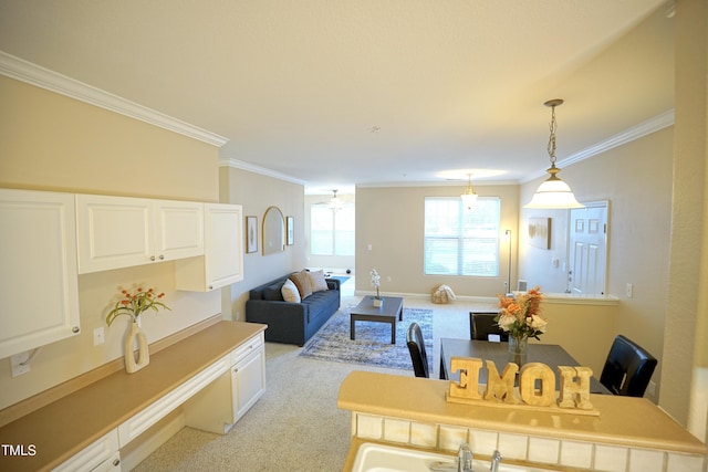 living area featuring baseboards, ornamental molding, and light colored carpet