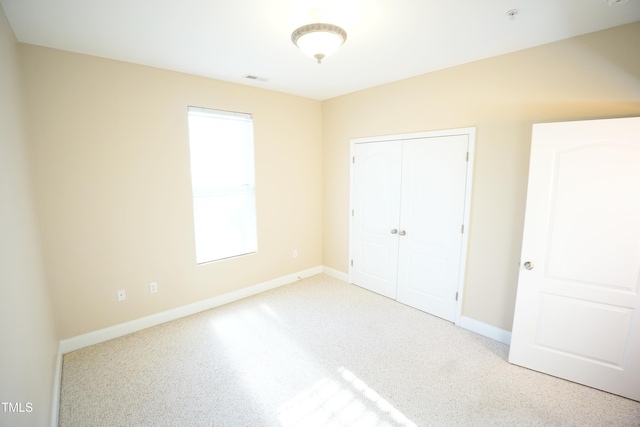 unfurnished bedroom featuring a closet and baseboards