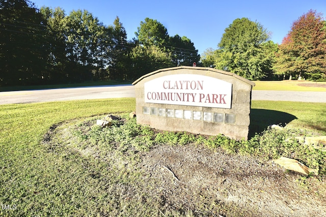 community / neighborhood sign with a lawn