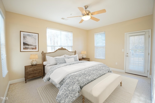 bedroom featuring access to outside, visible vents, baseboards, and ceiling fan