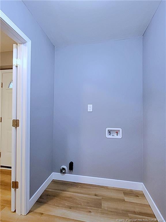 clothes washing area with hookup for a washing machine and light hardwood / wood-style flooring