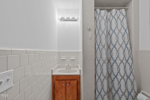 435 Tant Rd, Zebulon, NC 27597 - full bath with tile walls, a shower with shower curtain, wainscoting, and vanity