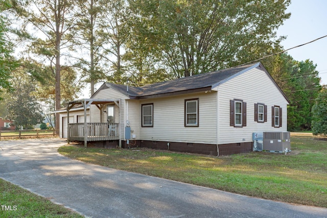 435 Tant Rd, Zebulon, NC 27597 - view of front of house with crawl space, central AC, concrete driveway, a front lawn, and a shingled roof