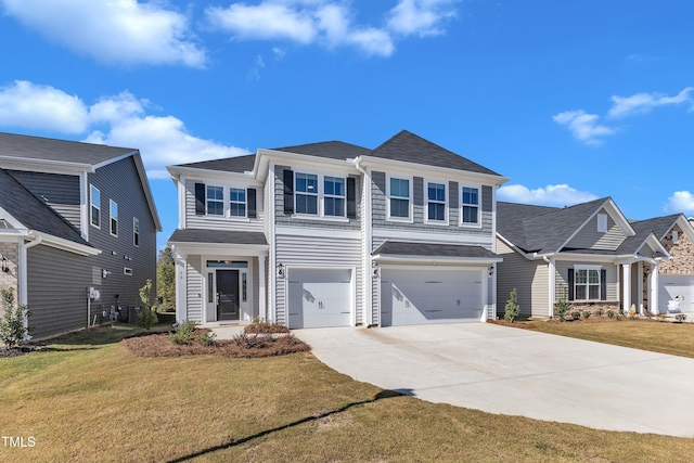 view of front of house featuring a garage and a front lawn