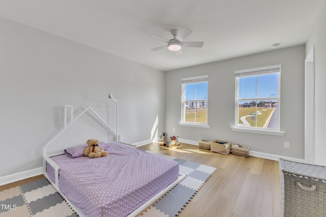 bedroom with wood-type flooring and ceiling fan