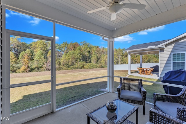 sunroom / solarium featuring ceiling fan and a wealth of natural light