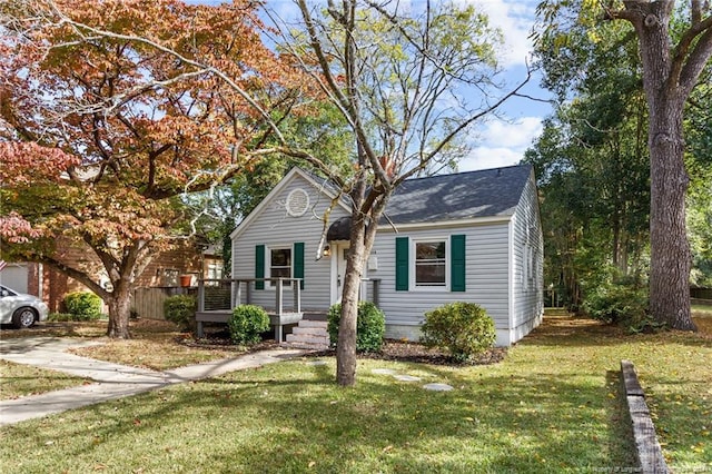 view of front of house featuring a front lawn and a wooden deck