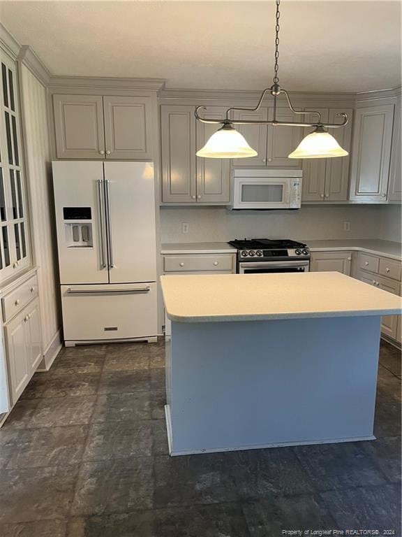 kitchen with gray cabinets, a center island, hanging light fixtures, and white appliances