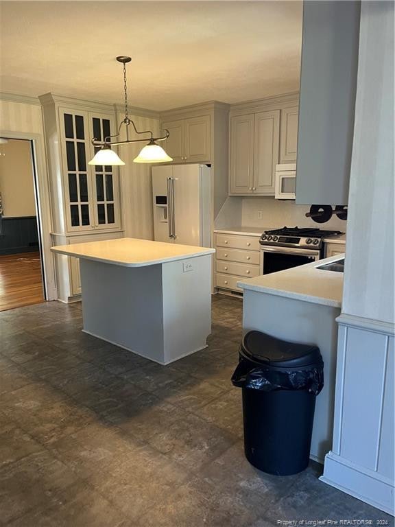 kitchen with a breakfast bar area, dark wood-type flooring, hanging light fixtures, a center island, and white appliances