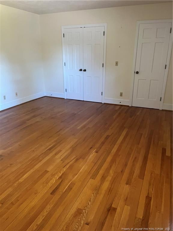 unfurnished bedroom with wood-type flooring