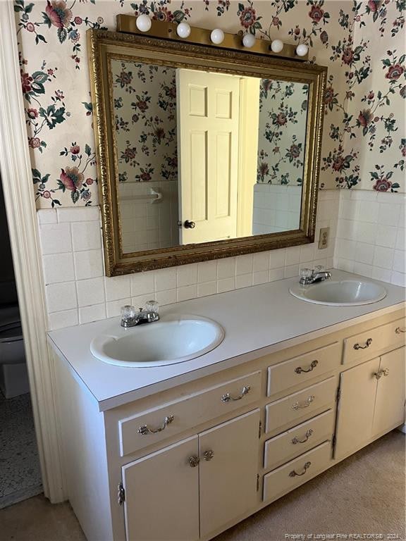 bathroom featuring vanity and toilet