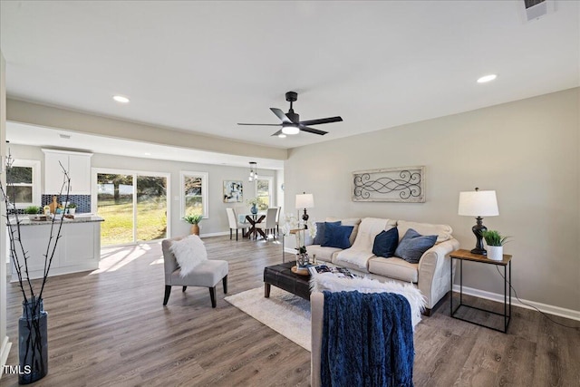 living room with hardwood / wood-style floors and ceiling fan