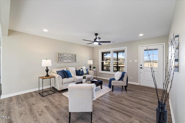 living room featuring ceiling fan and hardwood / wood-style flooring