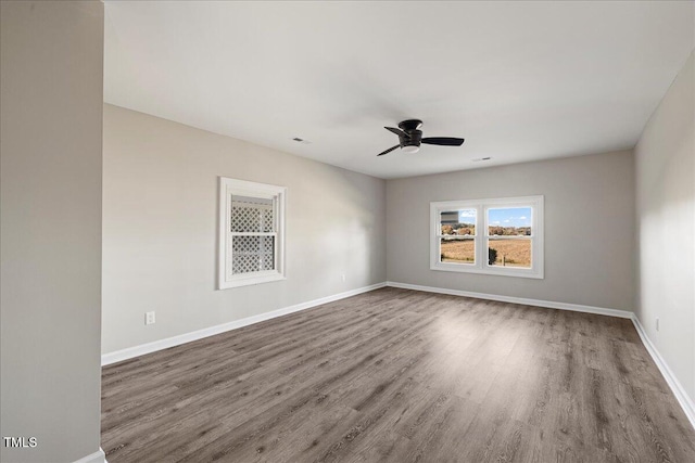 empty room featuring hardwood / wood-style flooring and ceiling fan