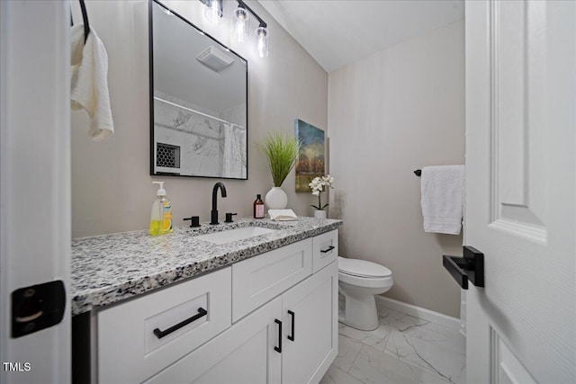 bathroom featuring vanity, toilet, and walk in shower