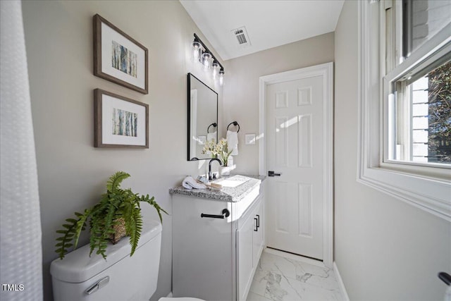 bathroom featuring vanity and toilet