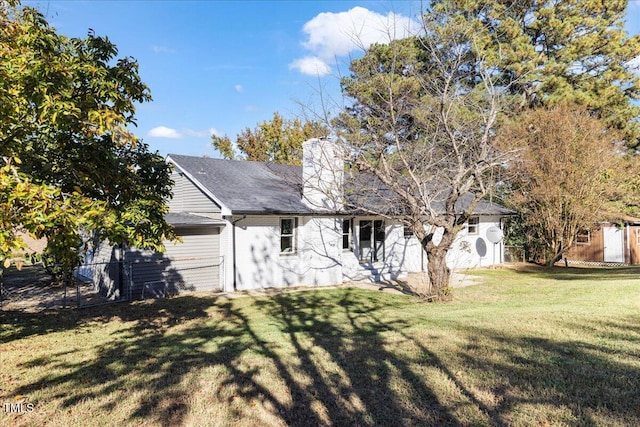 rear view of property featuring a yard