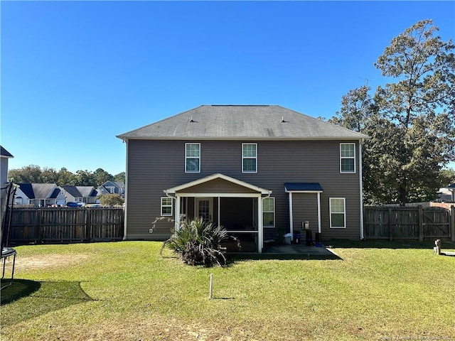 back of property featuring a patio, a yard, and a sunroom