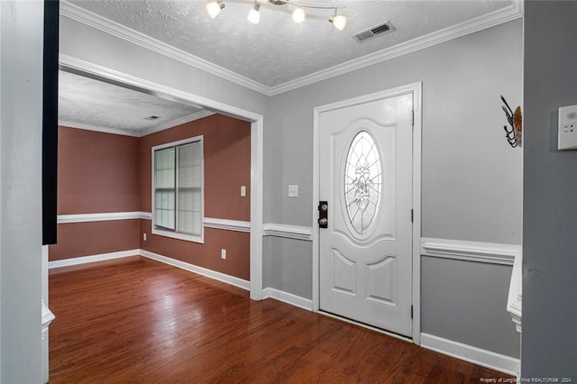 entrance foyer with crown molding, hardwood / wood-style flooring, and a textured ceiling