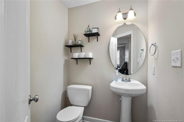 bathroom with toilet and sink