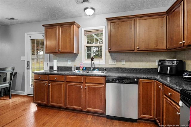 kitchen with plenty of natural light, stainless steel appliances, sink, and light wood-type flooring