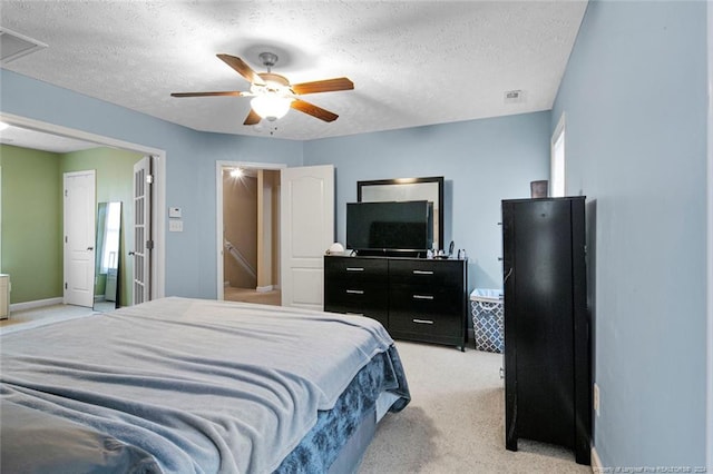 carpeted bedroom with a textured ceiling and ceiling fan