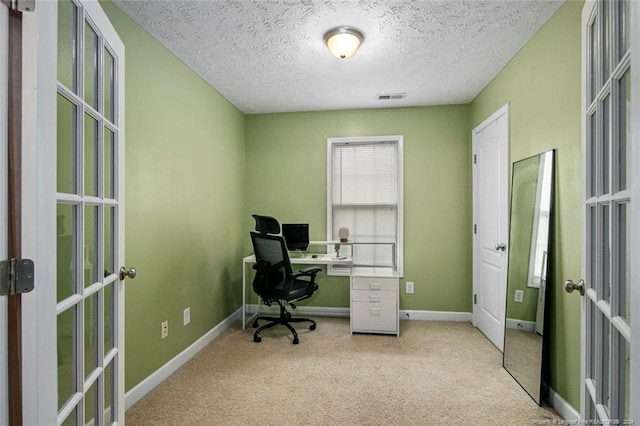 office area featuring french doors, a textured ceiling, and light colored carpet