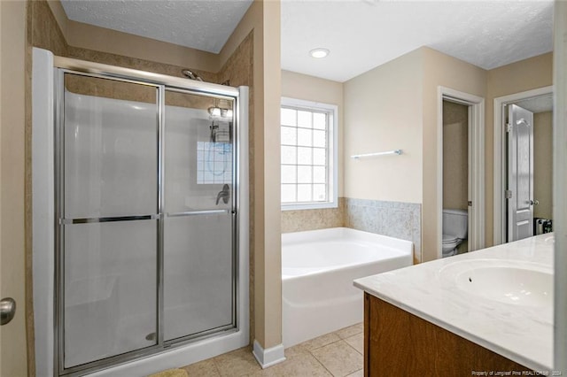 full bathroom with vanity, toilet, a textured ceiling, and shower with separate bathtub