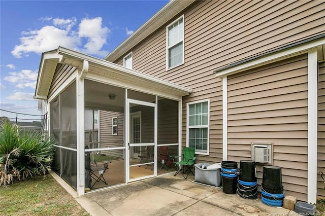 exterior space featuring a patio area and a sunroom