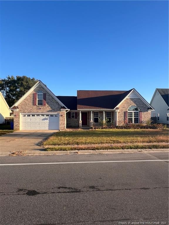 view of front facade with a front yard and a garage